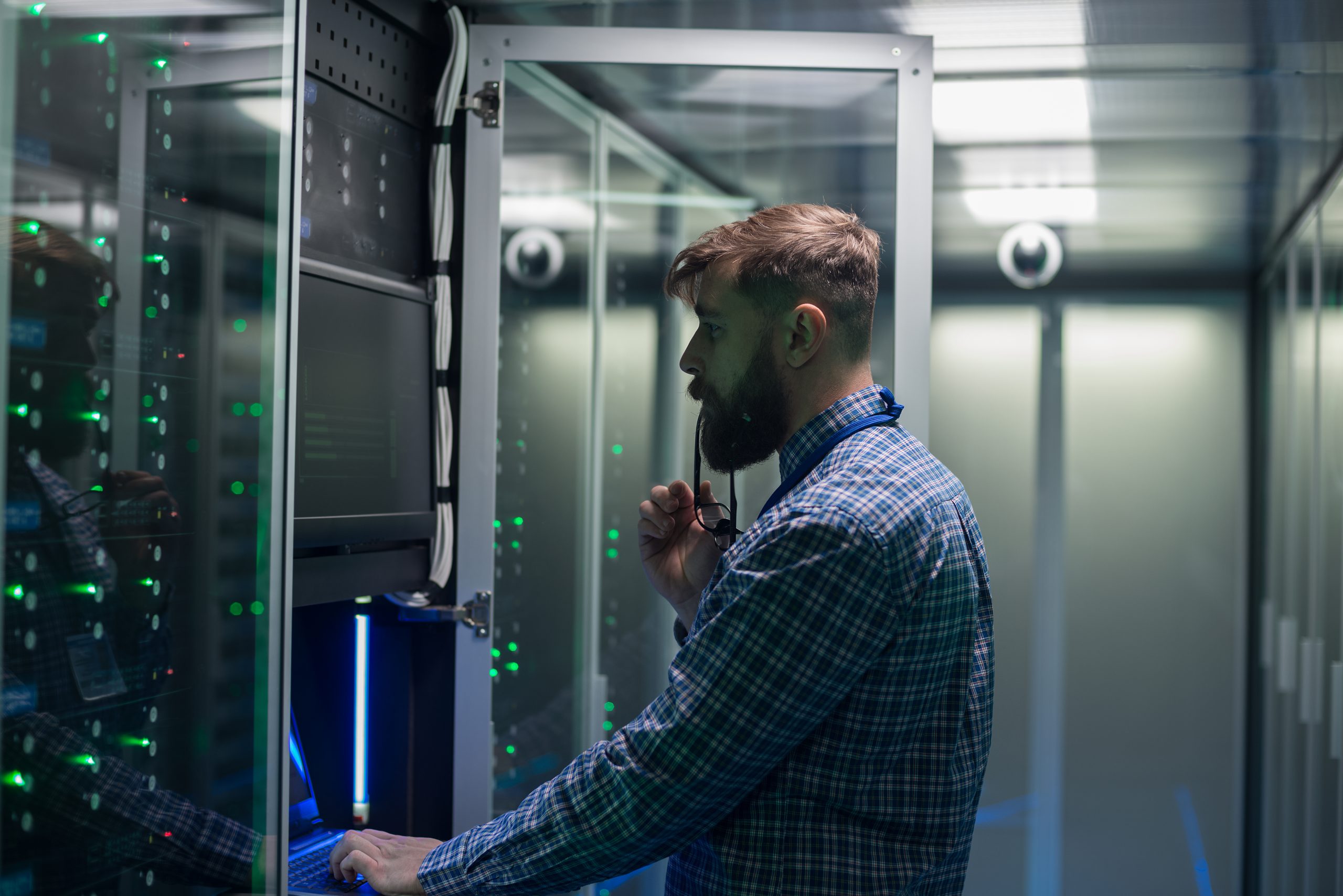 Tech support man standing in front of server cabinet